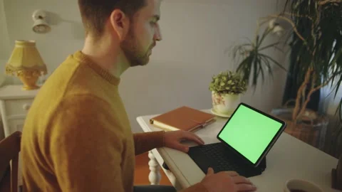 Person Working Desk Remotely Freelancer Greenscreen Laptop Tablet Video stock 195289724
