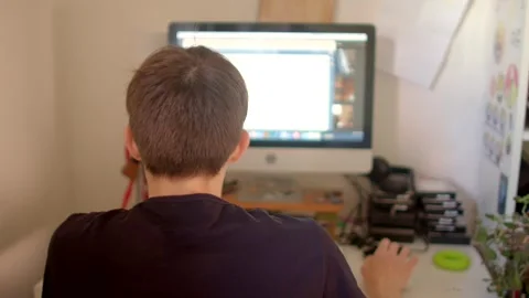 A person working intently at a computer with great attention to detail Stock Footage 311205001
