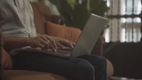 Person working on laptop from couch Stock Footage 341892656