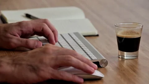 Person Working on Laptop, Taking Notes and Drinking Coffee Stock Footage 337826702