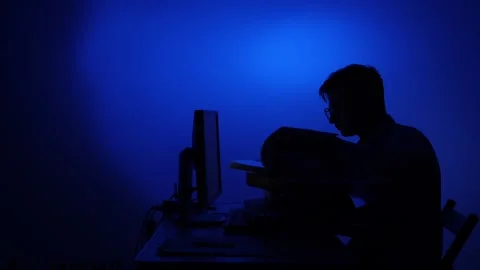 Person working late night behind computer screen Stock Footage 318982256