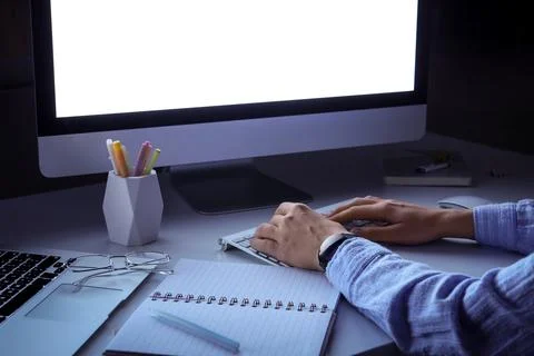 Person working late at night on computer, overtime and remote work, home offi Stock Photos