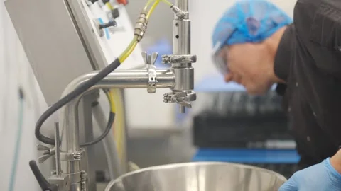 A person is working on a machine with a blue hose Stock Footage 297840756