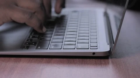 Person Working on a Notebook Computer at a Wooden Desk. Stock Footage 342277626