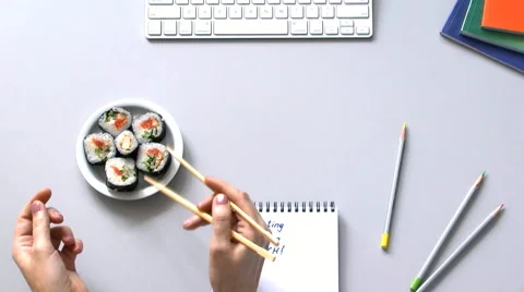 Person working in the office decided to have   lunch Sushi Stock Footage 61931867