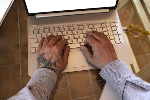 Person working remotely using laptop at home office Stock Photos