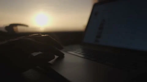 A person works on a computer during sunset in a motorhome. Digital nomad Stock Footage 231476700