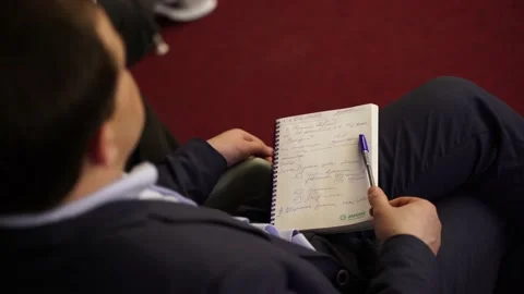 A person writes in a notebook Stock Footage 177083578