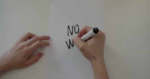 A person writes on paper no war Stock Footage 232137258