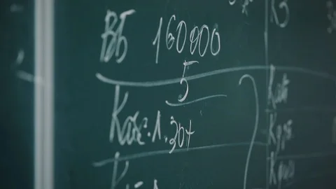 Person writes problem and solution on blackboard with chalk Stock Footage 117626700