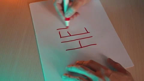 A person writes the word 'HELP' in red on a sheet of paper using a marker. The Видео 337558832