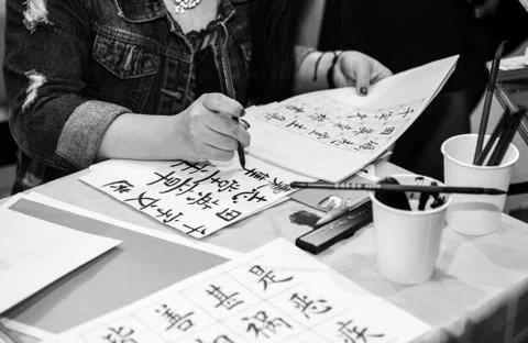A person writing chinese Stock Photos