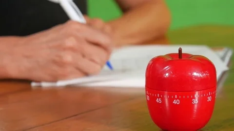 Person Writing with a Food Timer on a Table. Video stock 72632428