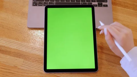 Person is writing on a green tablet Stock Footage 314325915