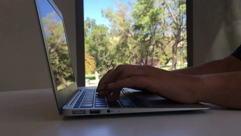 Person writing on a laptop 스톡 동영상 131419183