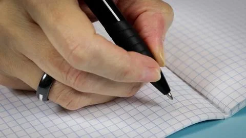 Person writing in a notebook Stock Photos