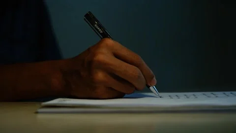 Person Writing Notes in a Notebook, Close-up of a person writing with a pen.. Stock Footage 346484102
