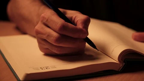 Person writing notes in notebook Stock Footage 332208169