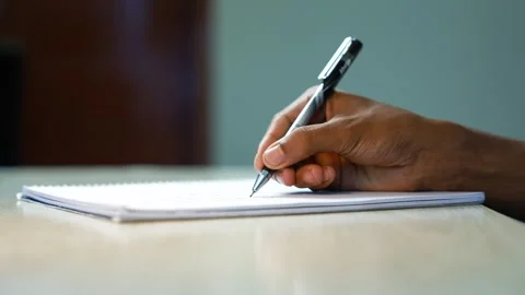 Person Writing Notes in an Open Notebook, Close-up of a person writing with.. Stock Footage 346484170