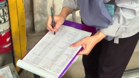 Person writing on a paper form attached to a clipboard Stock Footage 320676562