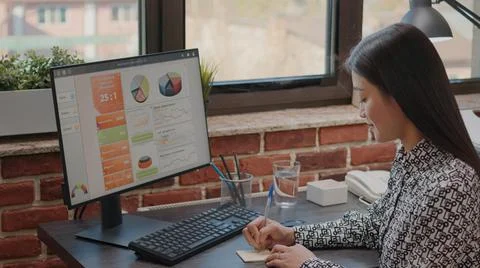 Person writing on sticky notes to remember task on computer Stock Photos