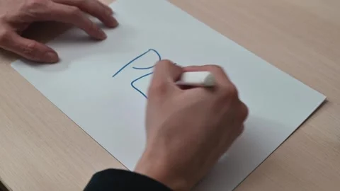 A person is writing the word plan on a piece of paper in four stages. The Stock Footage 337550329