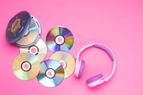Personal compact portable CD player disks purple headphones on a pink background Stock Photos