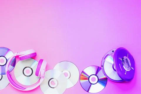 Personal compact portable CD player disks purple headphones on a pink background Stock Photos