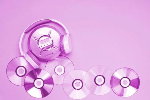 Personal compact portable CD player disks purple headphones on a pink background Stock Photos