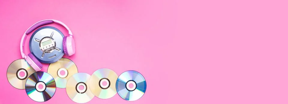 Personal compact portable CD player disks purple headphones on a pink background Stock Photos