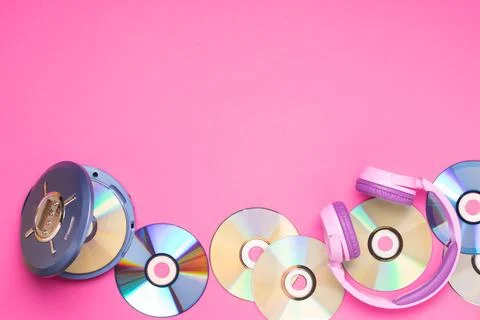 Personal compact portable CD player disks purple headphones on a pink background Stock Photos