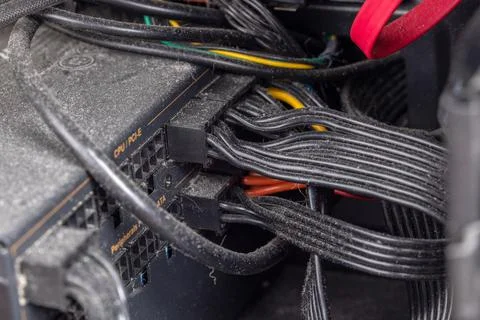 Personal computer black internal power cables and connectors covered with dust Foto stock