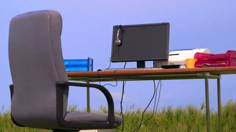 Personal computer on a desk in green field against blue sky Stock Footage 39505272