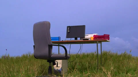 Personal computer on a desk in green field against blue sky Stock Footage 39505278