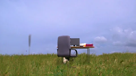 Personal computer on a desk in green field against blue sky Stock Footage 39505321