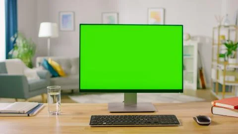 Personal Computer with Mock-up Green Screen Display Standing on the Desk Stock Photos