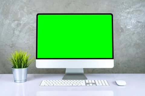 Personal Computer with Mock-up Green Screen Monitor Stands on the Office Desk Stock Photos