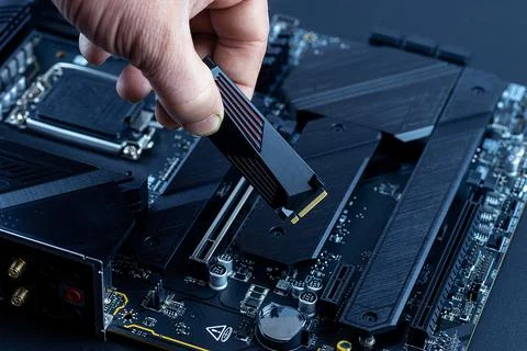Personal computer technicians mounting ssd drive on the motherboard socket,.. Stock Photos
