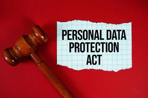 Personal Data Protection Act text written on rip paper with wooden judgment.. Stock Photos