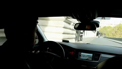Personal driver drives a car in the central part of Paris Stock Footage 263829249