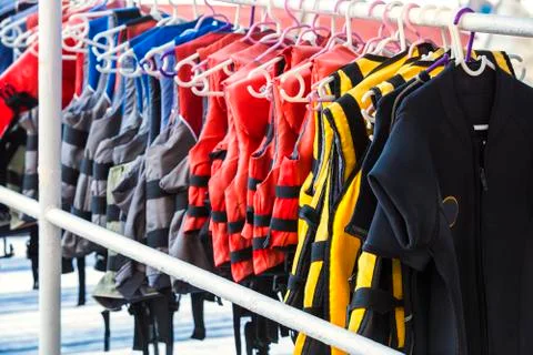 Personal flotation device as a life jacket in store. Many bright life jackets Stock Photos