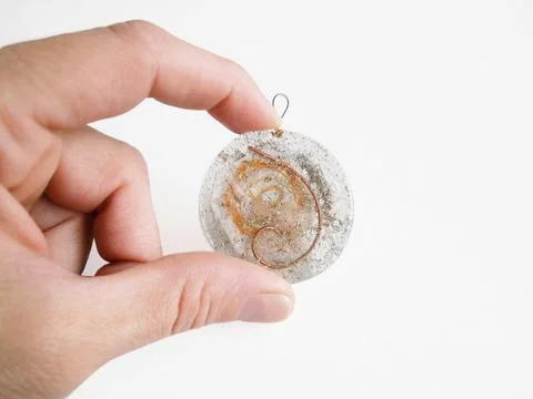 Personal Orgone for electromagnetic fields harmonizer between female finguers Stock Photos
