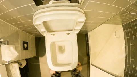 Personal perspective of a Caucasian man going to the toilet in a hotel bathroom Stock Footage 79163692