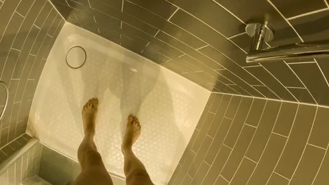 Personal perspective of a Caucasian man having a shower in a hotel bathroom Video stock 79165576
