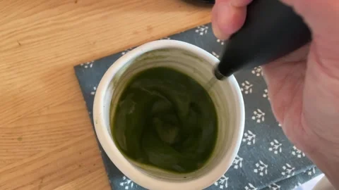 Personal perspective making matcha with a whisk Stock Footage 293164093
