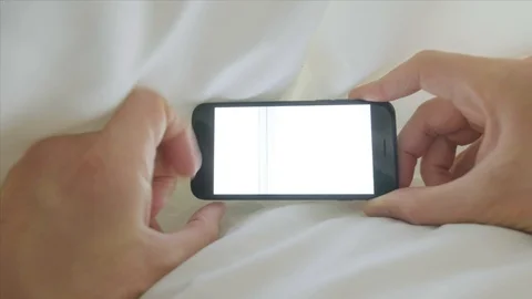 Personal perspective of a man looking a smartphone in bed POV Video stock 96110001