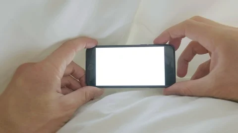 Personal perspective of a man looking a smartphone in bed POV Video stock 96110233