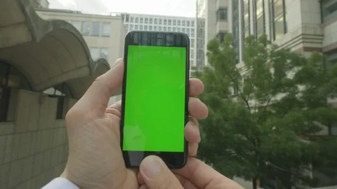 Personal perspective of a man using a Green-Screen smartphone outside the office Video stock 92522900