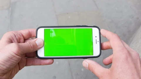Personal perspective of a man using a smartphone with a green-screen Stock Footage 104115081