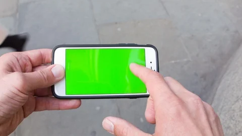 Personal perspective of a man using a smartphone with a green-screen Video stock 104115483